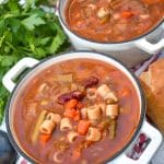Italian vegetable minestrone soup in two small cast iron bowls
