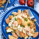 shrimp and rice casserole on a small blue plate with a fork resting on the side