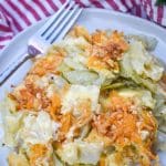 southern cabbage casserole on a white plate with a silver fork on the side