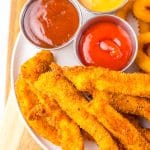 a closeup of homemade chicken fries on a white plate