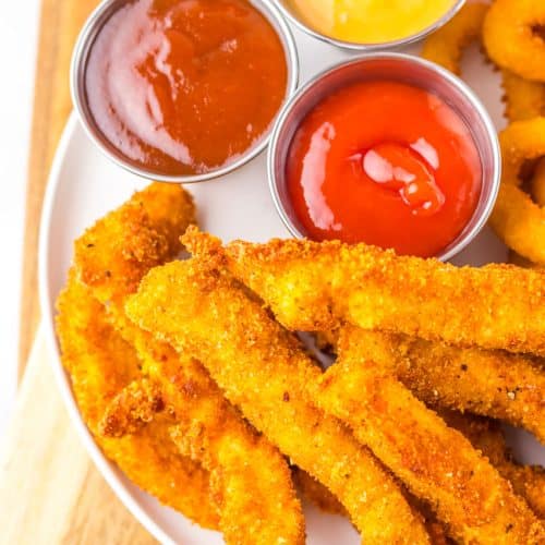 a closeup of homemade chicken fries on a white plate