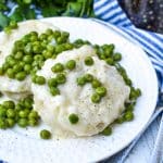 homemade peas and dumplings on a small white plate