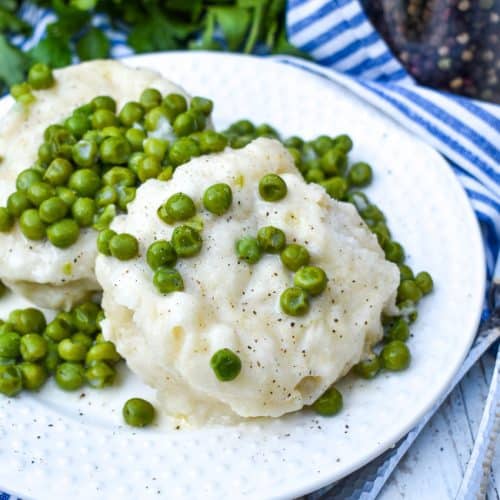 homemade peas and dumplings on a small white plate
