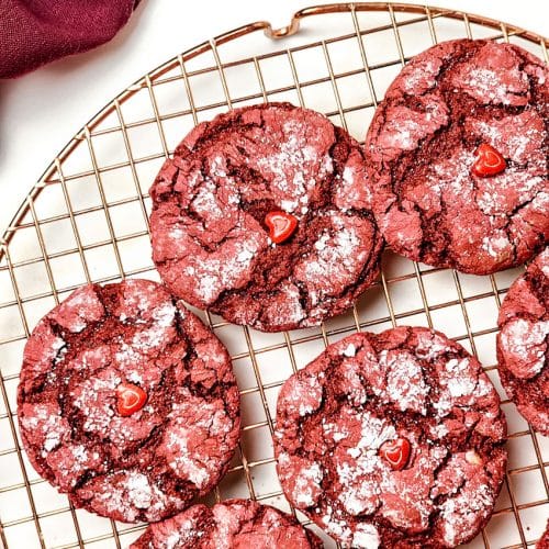 red velvet crinkle cookies cooling on a wire rack