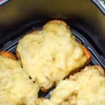 open face tuna melt sandwiches in the basket of an air fryer