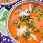 coconut curry soup with wontons in two small gray bowls