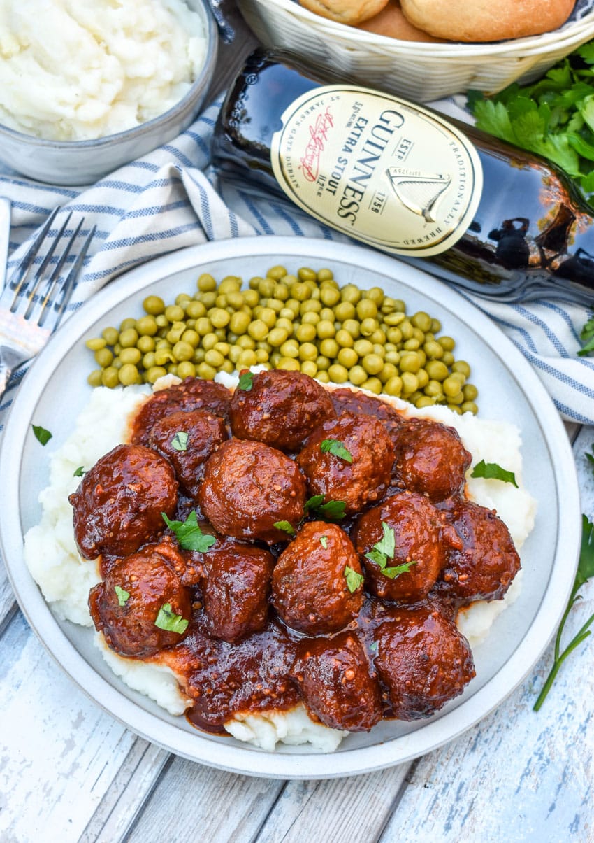 Guinness Meatballs (Slow Cooker Recipe) slow cooker guinness meatballs over mashed potatoes on a white plate