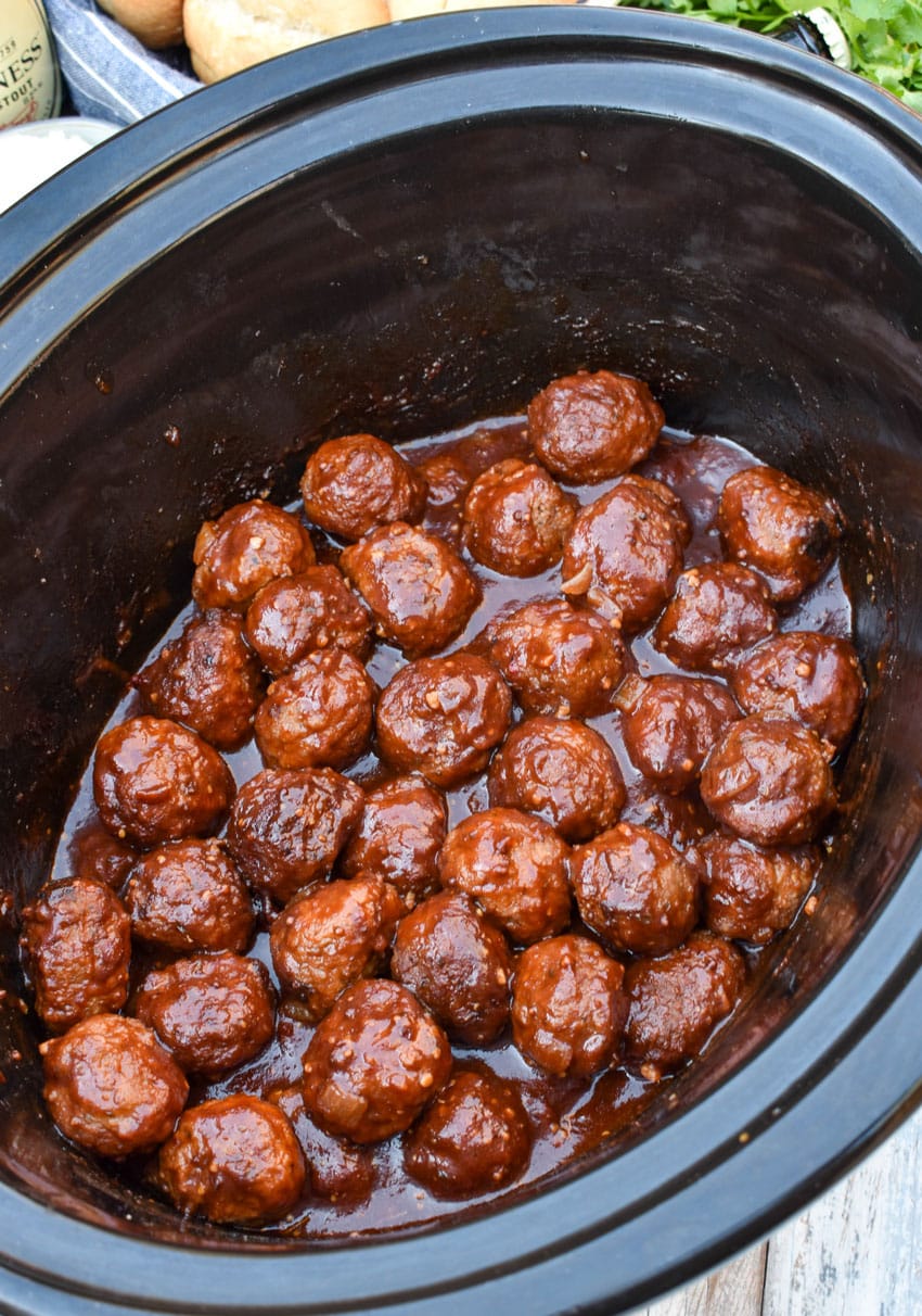 guinness meatballs in the black bowl of a slow cooker