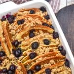 A BLUEBERRY PANCAKE CASSEROLE IN A WHITE SQUARE BAKING DISH