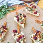 christmas cheese trees on a brown parchment paper covered wooden cutting board