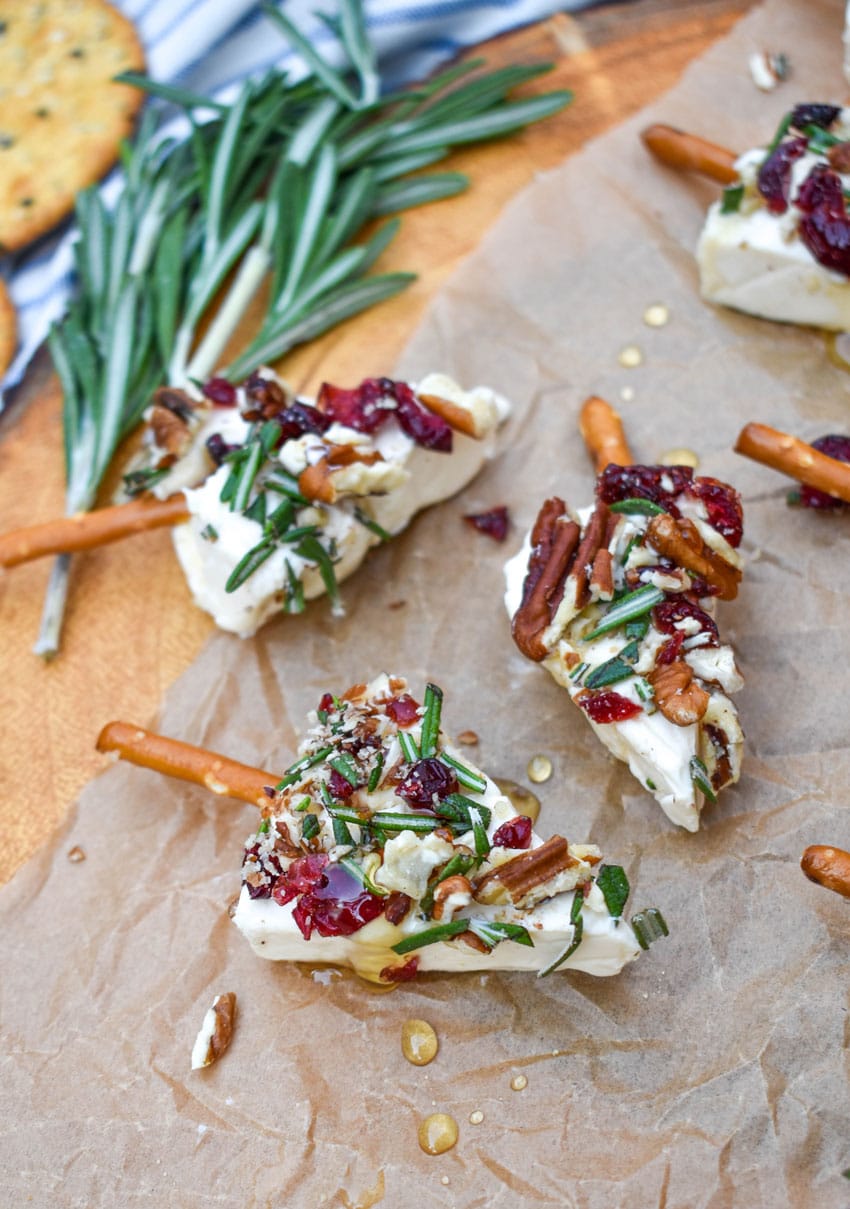 christmas cheese trees on a brown parchment paper covered wooden cutting board