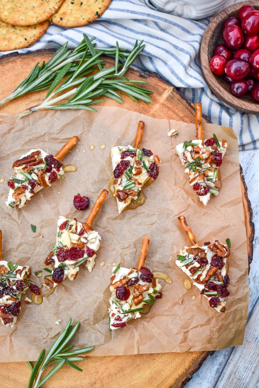 christmas cheese trees on a brown parchment paper covered wooden cutting board