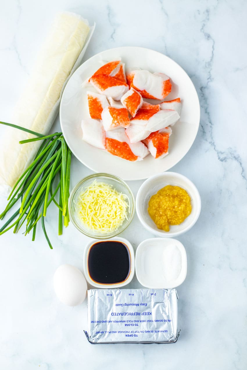 an overhead image showing the measured ingredients needed to make a batch of crab rangoon pinwheels
