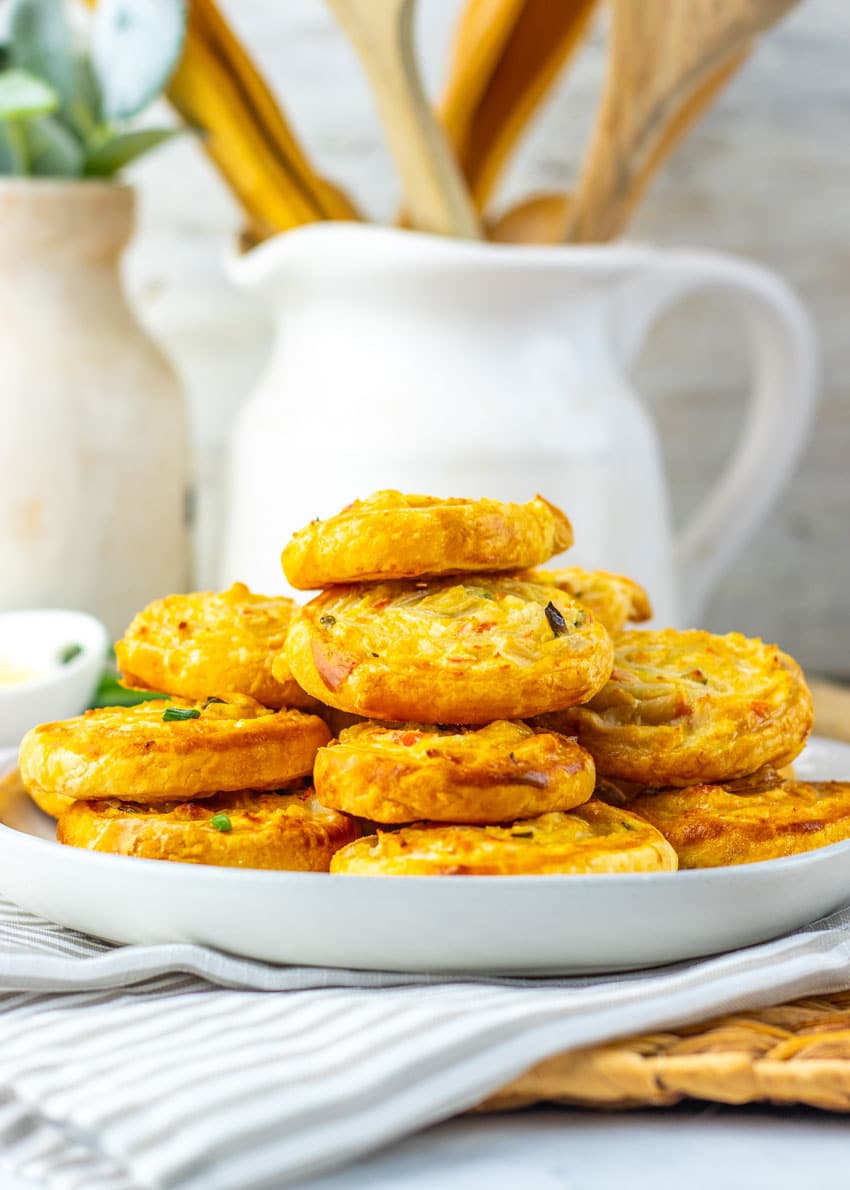 crab rangoon pinwheels stacked on a white plate
