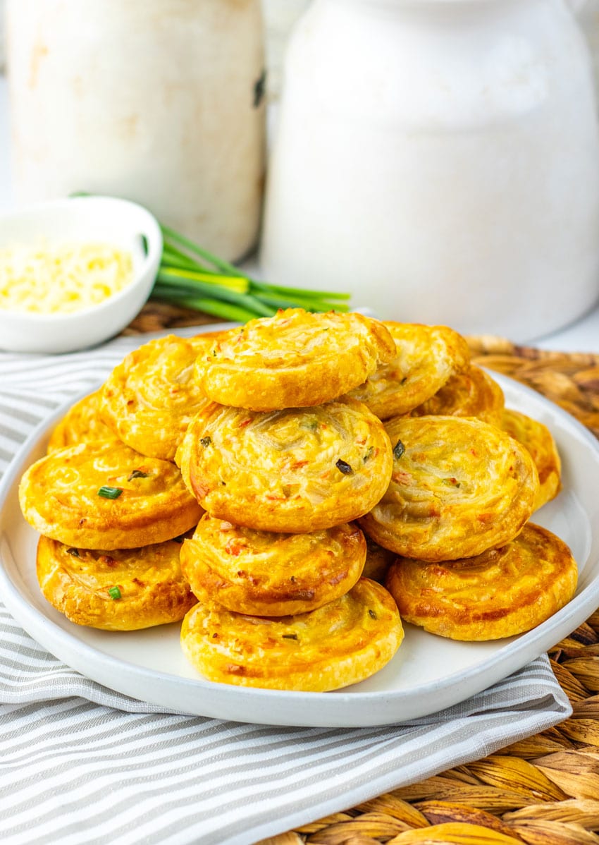 crab rangoon pinwheels stacked on a white plate