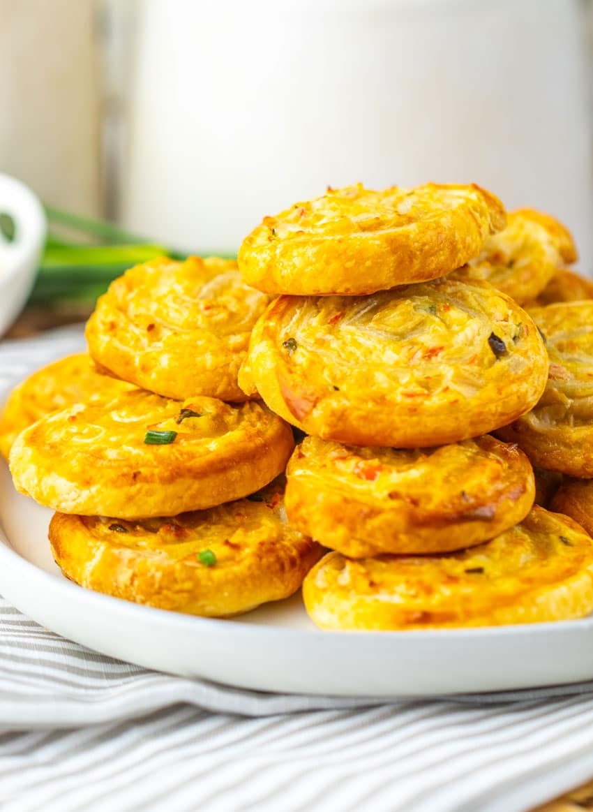 crab rangoon pinwheels stacked on a white plate