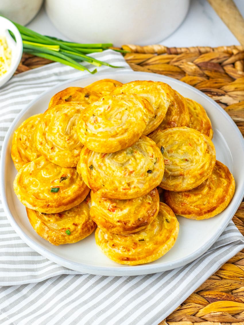 crab rangoon pinwheels stacked on a white plate