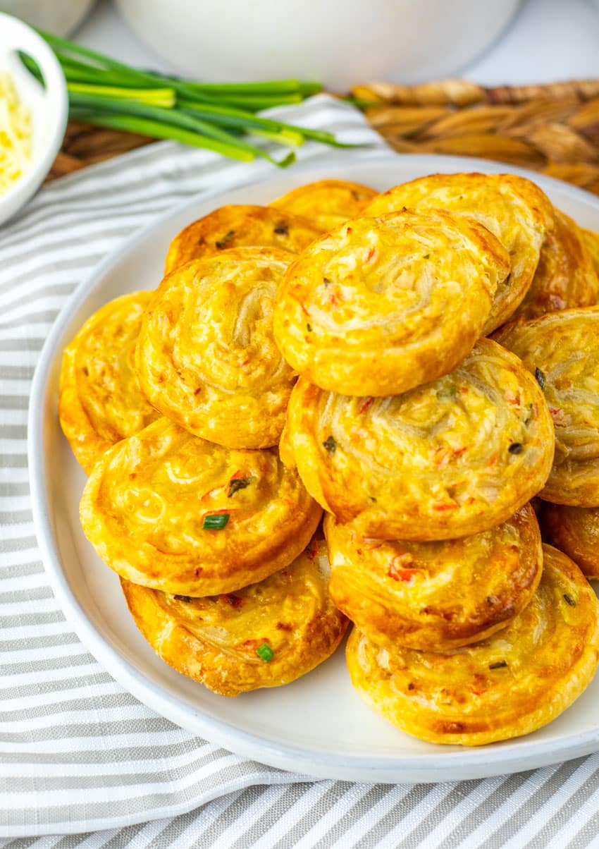 crab rangoon pinwheels stacked on a white plate