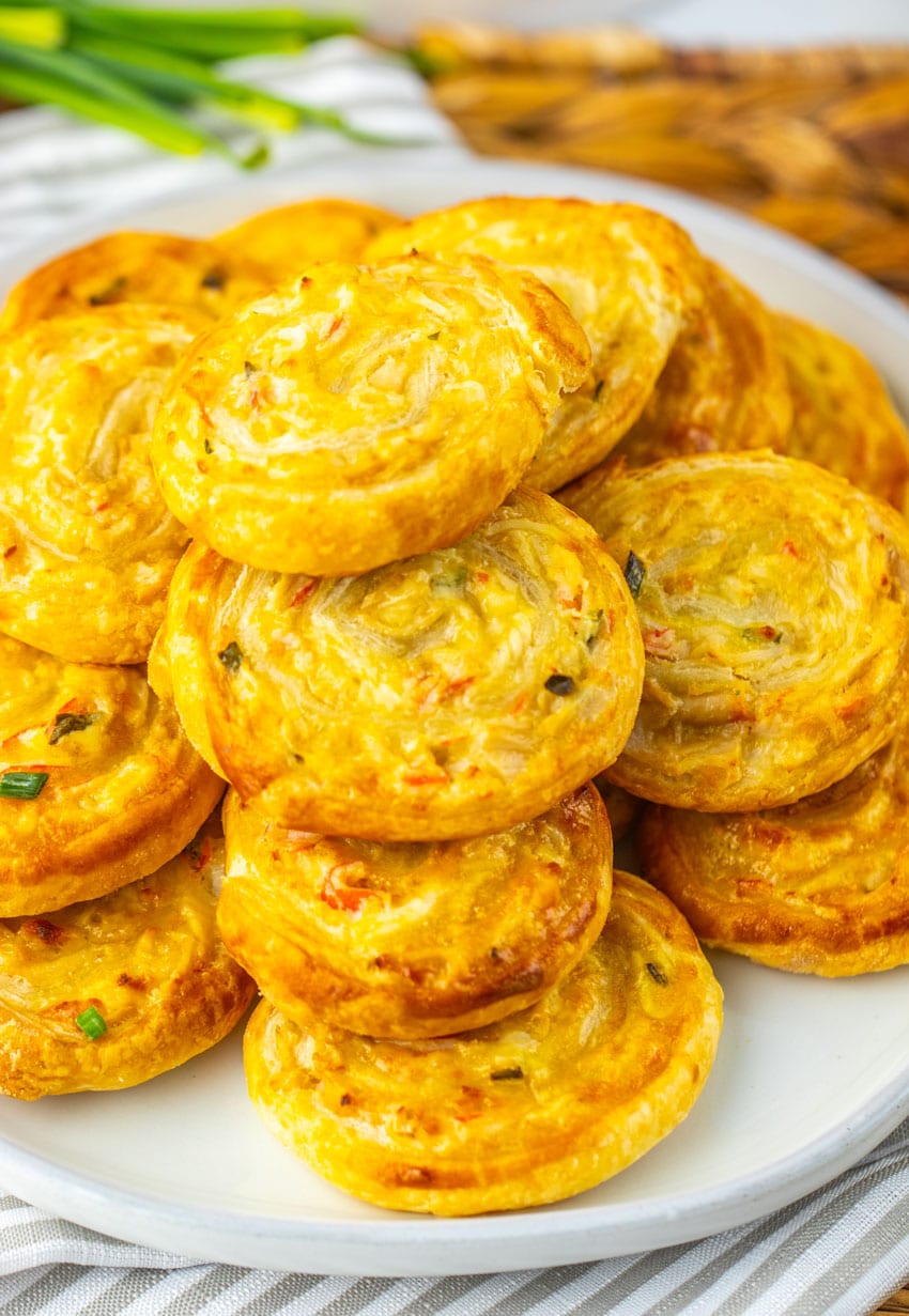 crab rangoon pinwheels stacked on a white plate