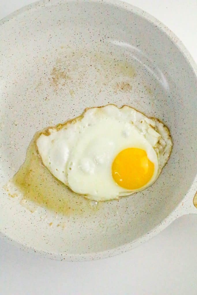 a fried egg in a white skillet