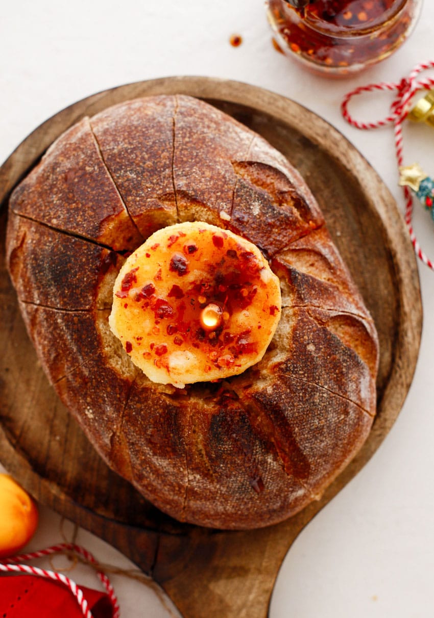 a lit hot honey butter candle in a hollowed out bread bowl