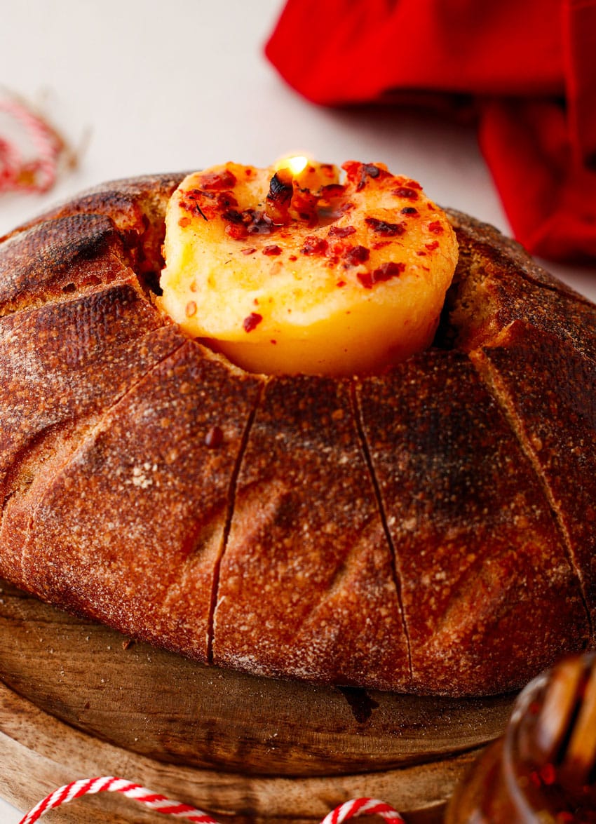 a lit hot honey butter candle in a hollowed out bread bowl