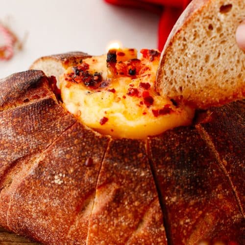 a lit hot honey butter candle in a hollowed out bread bowl