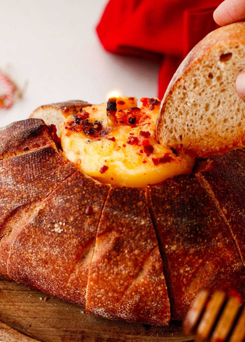 a lit hot honey butter candle in a hollowed out bread bowl