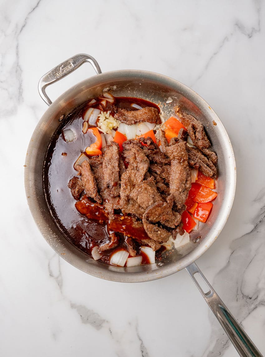 homemade beijing beef in a large stainless steel skillet