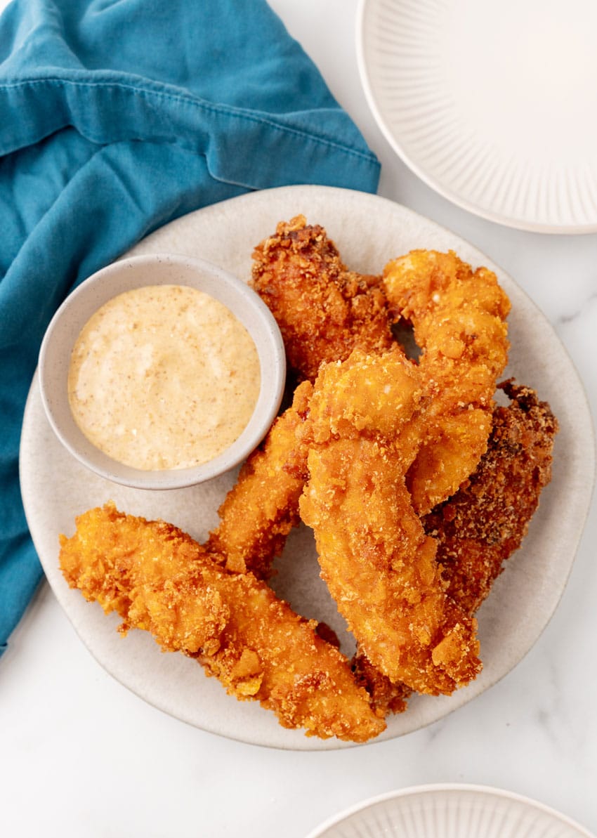 a pile of captain crunch chicken tenders on a white plate