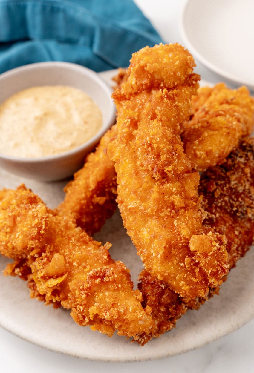 a pile of captain crunch chicken tenders on a white plate