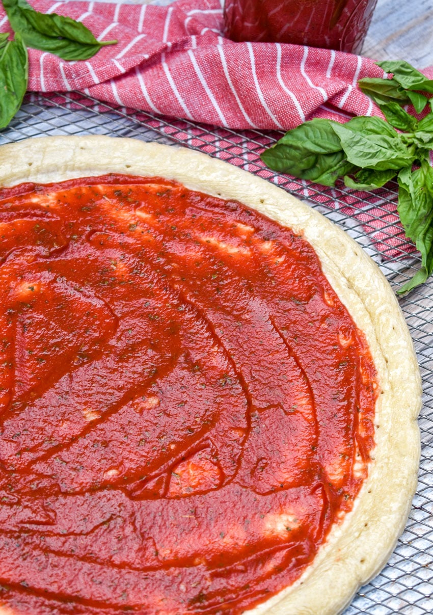 homemade 5 minute pizza sauce spread on a pizza crust