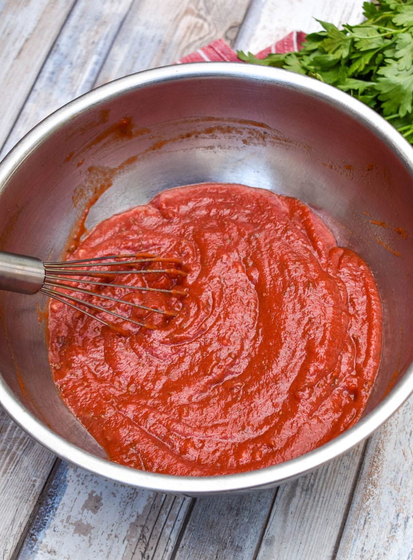 5 minute homemade pizza sauce in a large metal mixing bowl