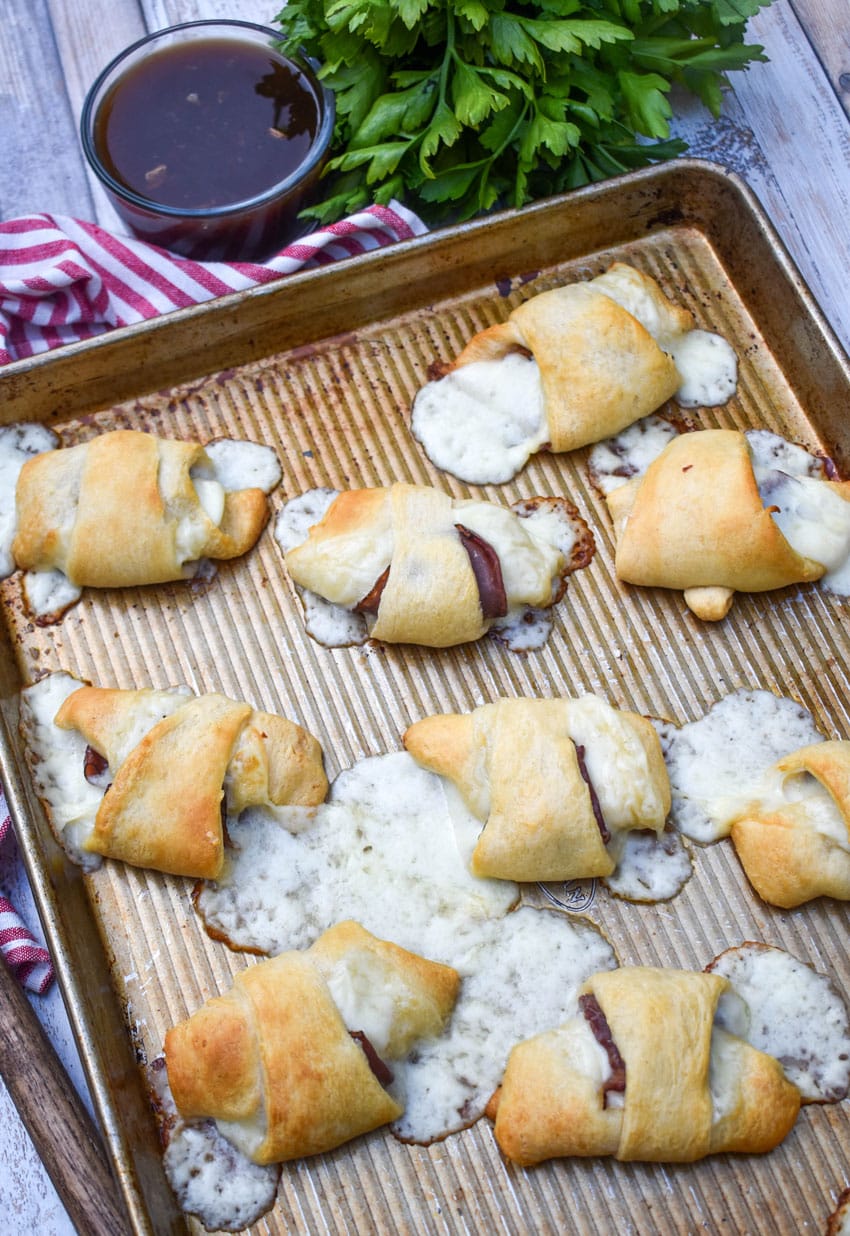 crescent roll french dips on a large baking sheet