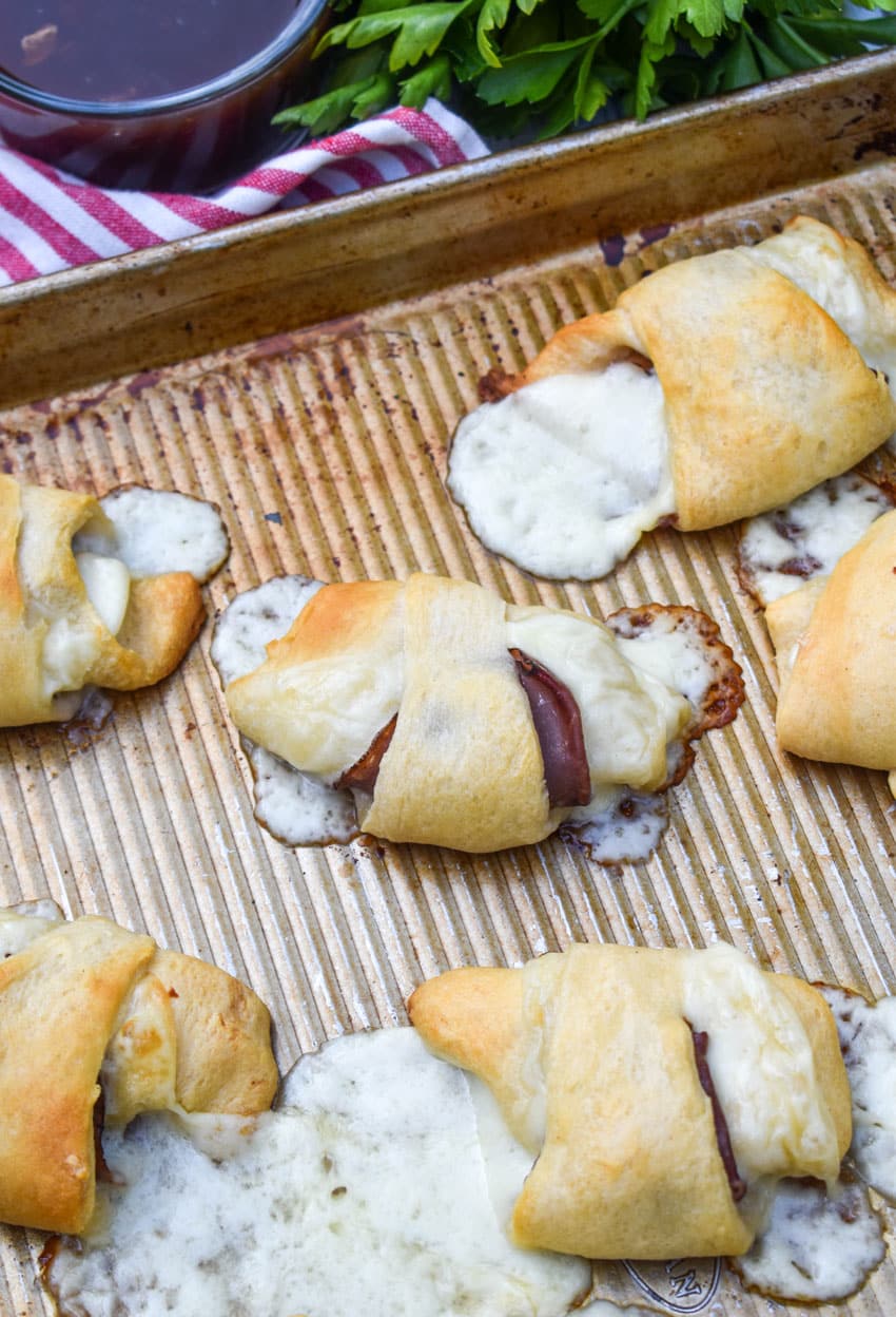 crescent roll french dips on a large baking sheet