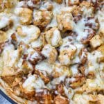 cheesy garlic parmesan chicken and potatoes in a large skillet