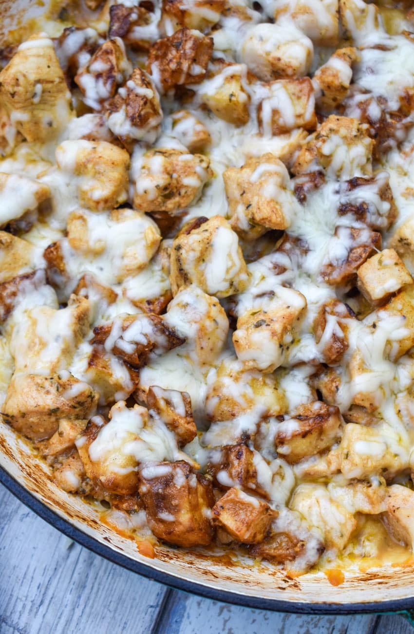 cheesy garlic parmesan chicken and potatoes in a large skillet