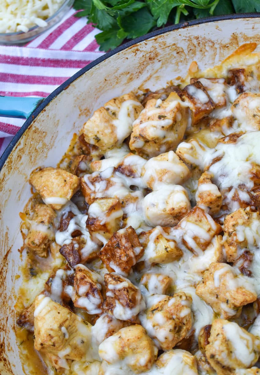 cheesy garlic parmesan chicken and potatoes in a large skillet