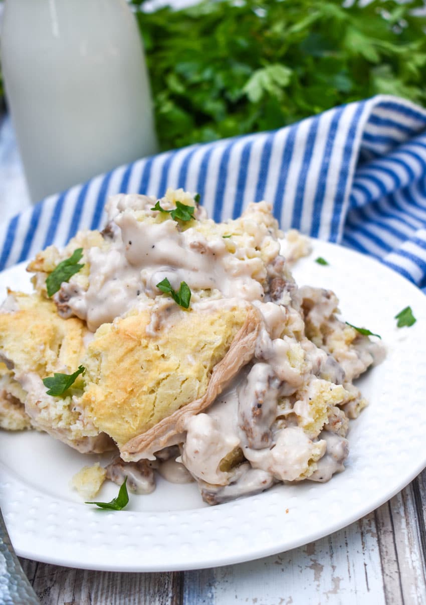 biscuits and gravy skillet on a small white plate with a silver fork resting on the side