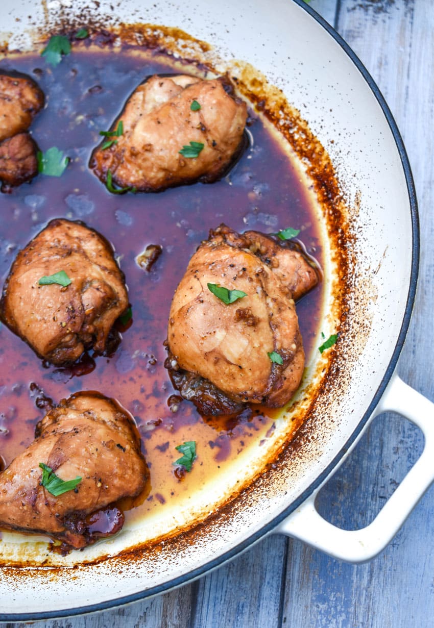 saucy balsamic chicken thighs in a cast iron skillet