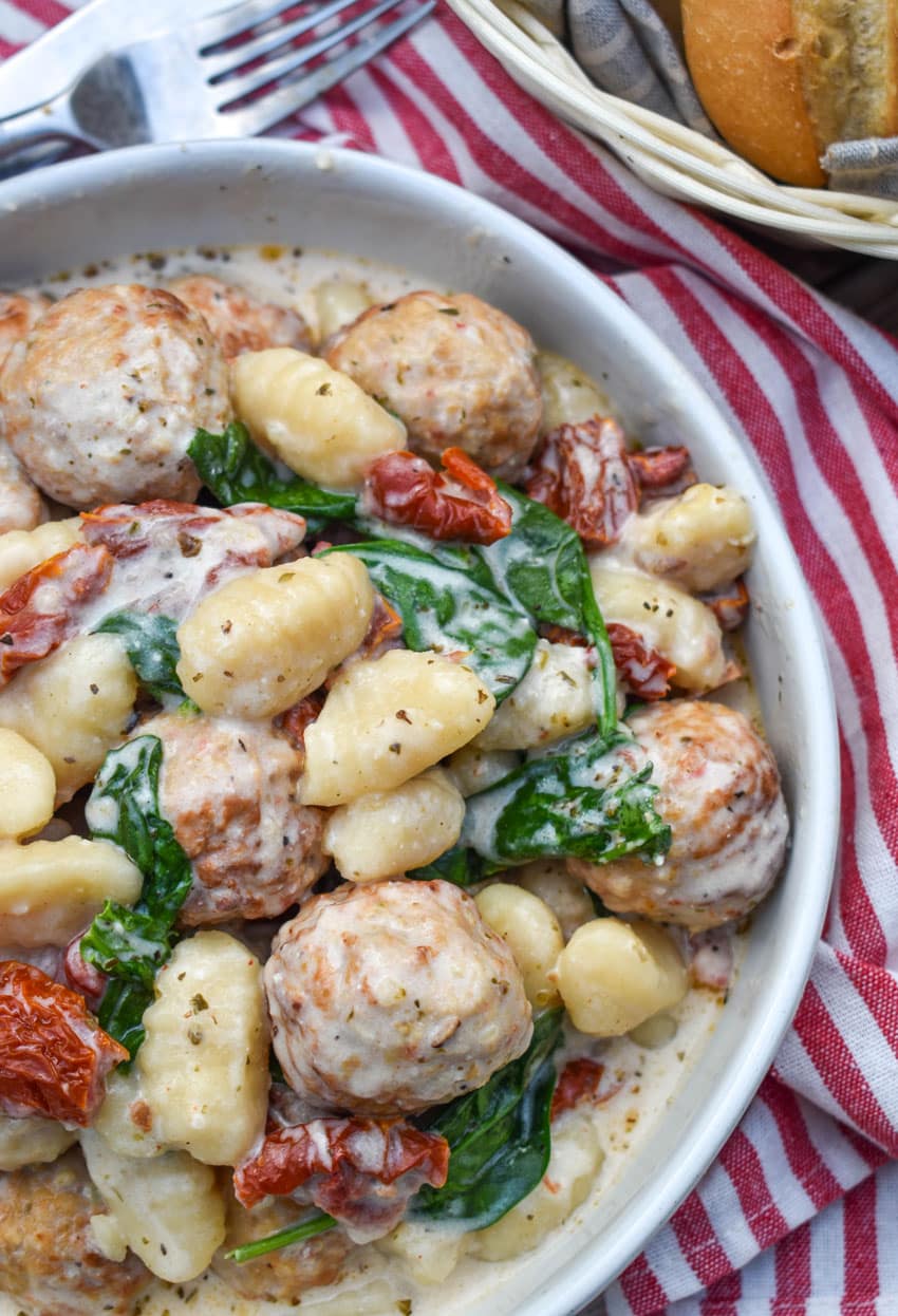 slow cooker marry me meatballs with gnocchi in a shallow white bowl