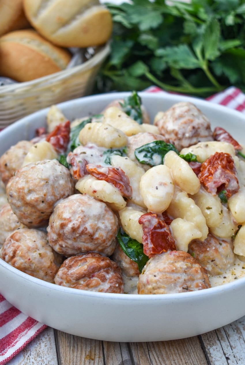 slow cooker marry me meatballs with gnocchi in a shallow white bowl