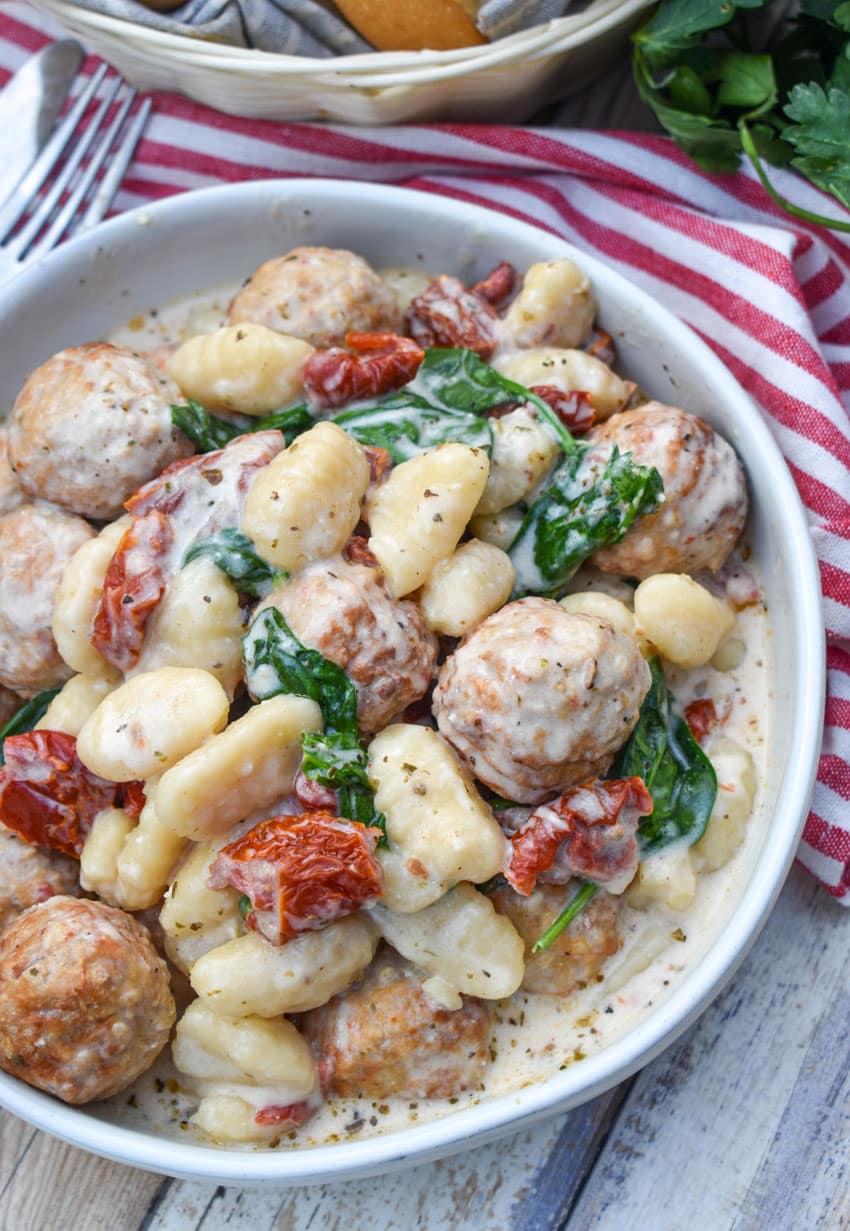 slow cooker marry me meatballs with gnocchi in a shallow white bowl