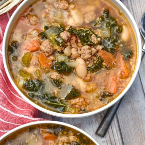 tuscan white bean soup with kale in two white bowls