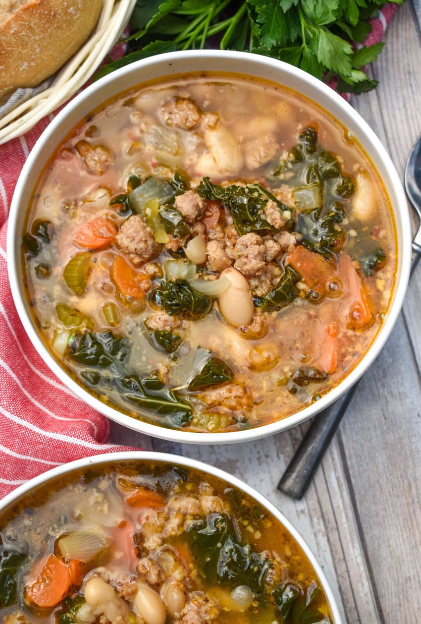 tuscan white bean soup with kale in two white bowls
