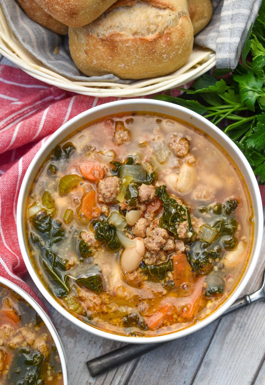 tuscan white bean soup with kale in two white bowls