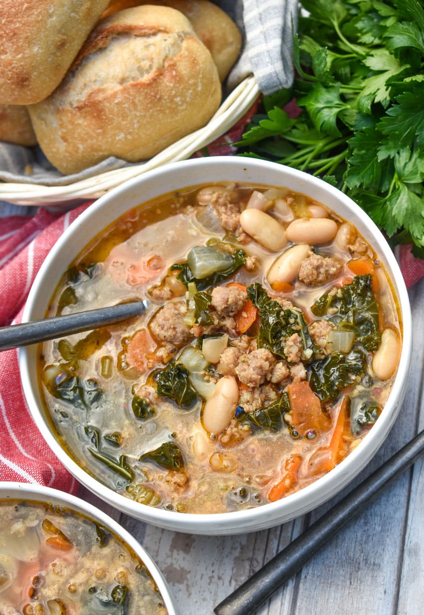 tuscan white bean soup with kale in two white bowls