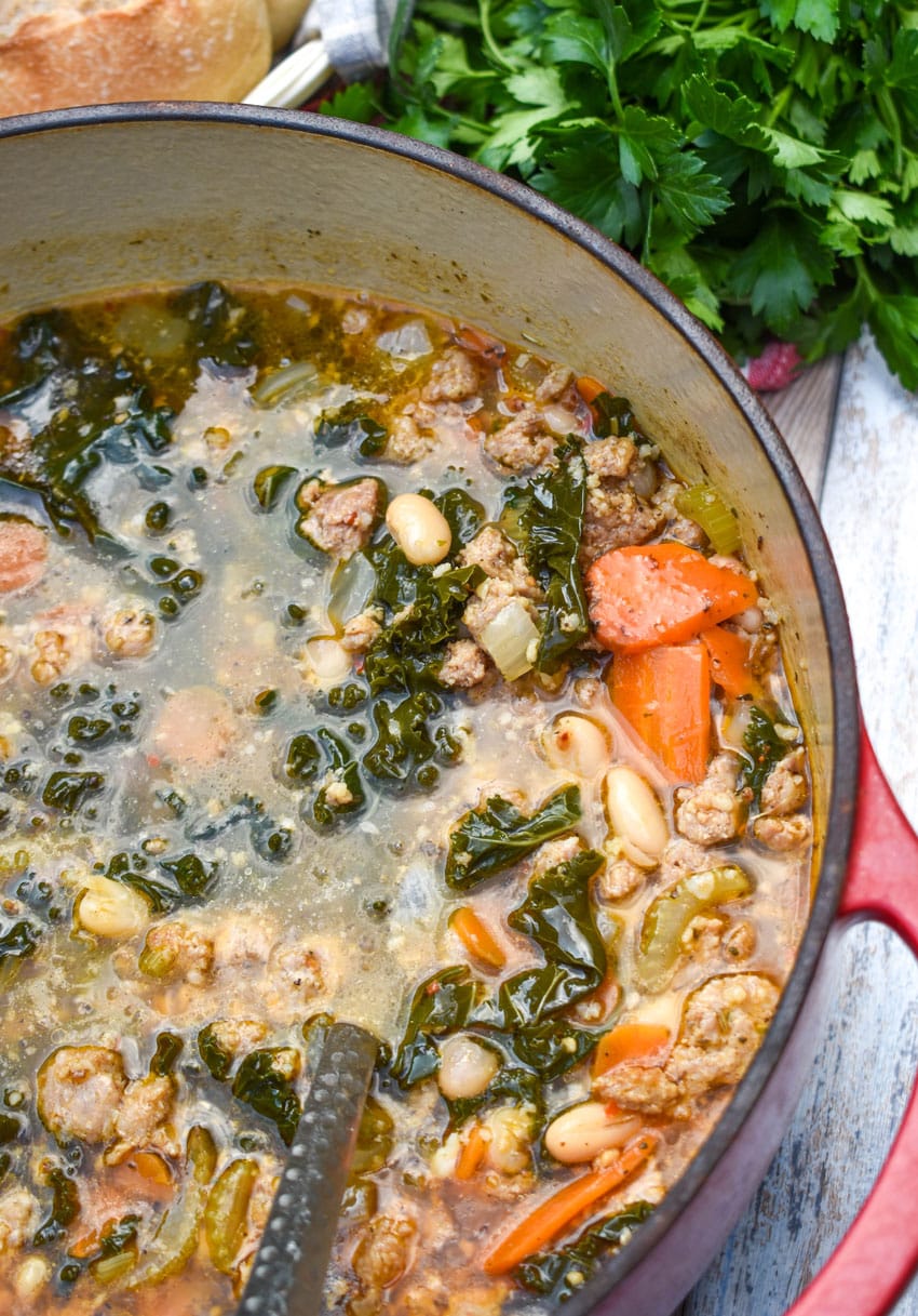 tuscan white bean soup with kale in a large red dutch oven