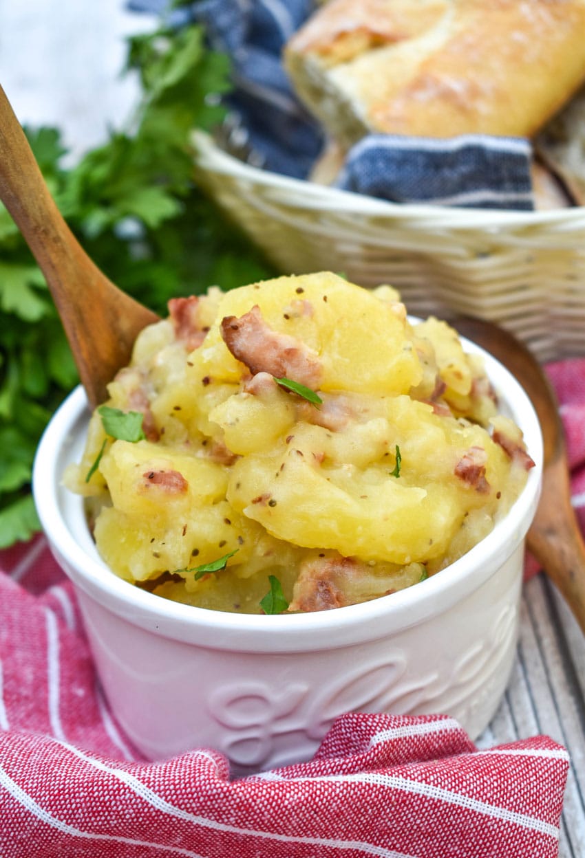 warm german potato salad in a small white bowl