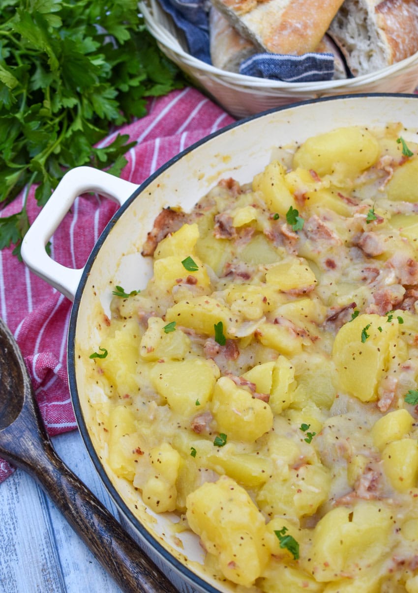 warm german potato salad in a large white skillet